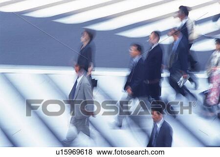 Business people crossing at the crosswalk, high angle view, blurred motion, Tokyo, Japan View Large Photo Image Stock Photo - Business people crossing at the crosswalk, high angle view, blurred motion, Tokyo, Japan. Fotosearch