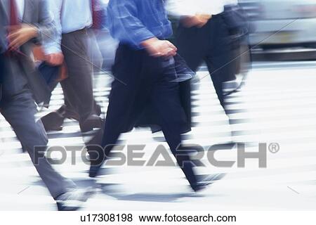 Stock Photo - Business people crossing at the crosswalk, blurred motion, Tokyo, Japan. Fotosearch