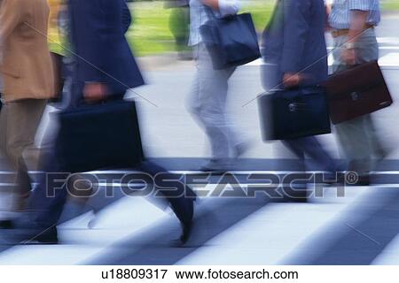Business people crossing at the crosswalk, side view, Tokyo, Japan View Large Photo Image Stock Photo - Business people crossing at the crosswalk, side view, Tokyo, Japan. Fotosearch