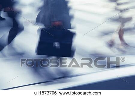 Stock Photograph - Business people crossing at the crosswalk, high angle view, blurred motion, Tokyo, Japan. Fotosearch