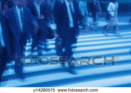 Business people crossing at the crosswalk, toned image, blurred motion, Tokyo, Japan View Large Photo Image Stock Photography - Business people crossing at the crosswalk, toned image, blurred motion, Tokyo, Japan. Fotosearch