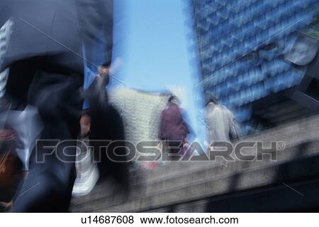 Business people walking up stairs, low angle view, blurred motion, Tokyo, Japan View Large Photo Image Stock Photo - Business people walking up stairs, low angle view, blurred motion, Tokyo, Japan. Fotosearch