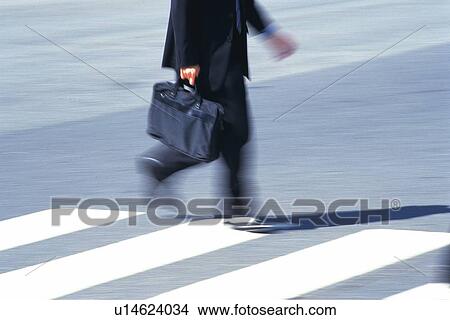 Businessman crossing at the crosswalk, side view, blurred motion, Tokyo, Japan View Large Photo Image Picture - Businessman crossing at the crosswalk, side view, blurred motion, Tokyo, Japan. Fotosearch