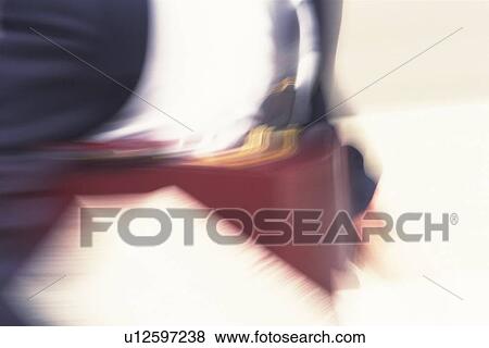 Stock Photo - Businessman, midsection, blurred motion, Tokyo, Japan. Fotosearch