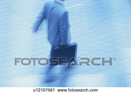 Businessman walking and holding briefcase, high angle view, blurred motion, toned image, Tokyo, Japan View Large Photo Image Stock Image - Businessman walking and holding briefcase, high angle view, blurred motion, toned image, Tokyo, Japan. Fotosearch