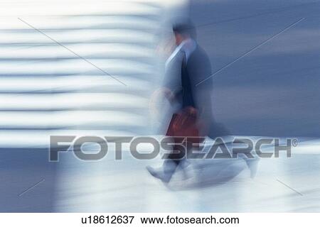 Businessman walking at the crosswalk, side view, blurred motion, Tokyo, Japan View Large Photo Image Stock Photo - Businessman walking at the crosswalk, side view, blurred motion, Tokyo, Japan. Fotosearch