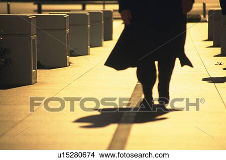 Picture - Businessman walking down street, low section, Tokyo, Japan. Fotosearch