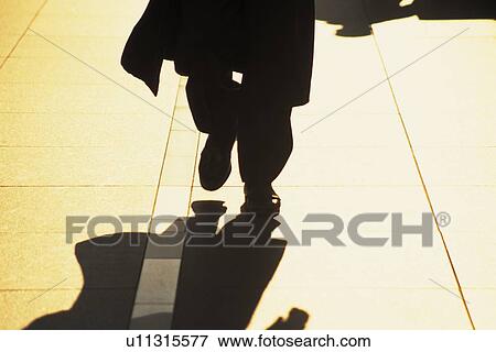 Businessman walking down street, low section, Tokyo, Japan View Large Photo Image Stock Photo - Businessman walking down street, low section, Tokyo, Japan. Fotosearch
