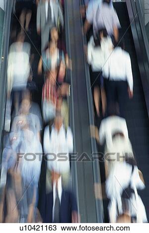 People riding escalators, high angle view, blurred motion, Tokyo, Japan View Large Photo Image Stock Image - People riding escalators, high angle view, blurred motion, Tokyo, Japan. Fotosearch