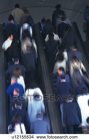 Picture - People riding escalators, low angle view, blurred motion, Tokyo, Japan. Fotosearch