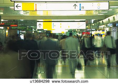 Stock Photo - People walking down in station, blurred motion, Tokyo, Japan. Fotosearch