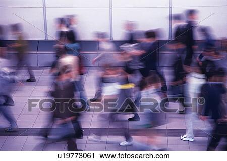 Stock Image - People walking down passage in station, high angle view, blurred motion, Tokyo, Japan. Fotosearch