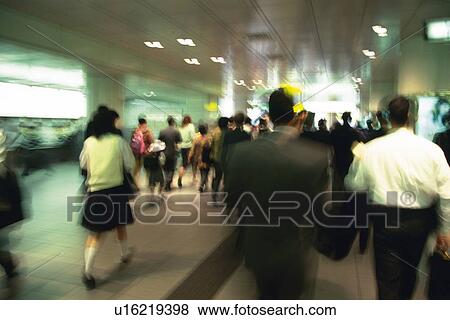 People walking down passage in station, high angle view, blurred motion, Tokyo, Japan View Large Photo Image Stock Photo - People walking down passage in station, high angle view, blurred motion, Tokyo, Japan. Fotosearch