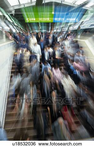 People walking down stairs at station, high angle view, blurred motion, Tokyo, Japan View Large Photo Image Stock Photograph - People walking down stairs at station, high angle view, blurred motion, Tokyo, Japan. Fotosearch