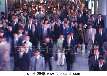 Stock Image - People walking down the passage, high angle view, blurred motion, Tokyo, Japan. Fotosearch