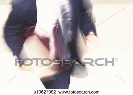 Stock Image - Running businessman, high angle view, blurred motion, Tokyo, Japan. Fotosearch