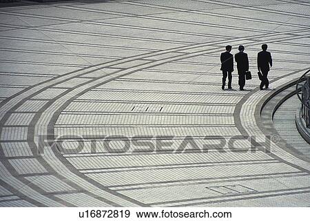 Three men walking side by side, high angle view, Tokyo, Japan View Large Photo Image Stock Photo - Three men walking side by side, high angle view, Tokyo, Japan. Fotosearch
