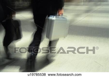 Two men walking and holding briefcase, high angle view, blurred motion, Tokyo, Japan View Large Photo Image Stock Photo - Two men walking and holding briefcase, high angle view, blurred motion, Tokyo, Japan. Fotosearch