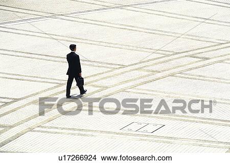 Walking businessman, high angle view, Tokyo, Japan View Large Photo Image Picture - Walking businessman, high angle view, Tokyo, Japan. Fotosearch