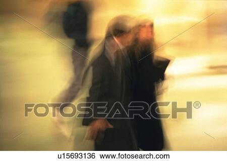 Stock Photograph - Business people walking down on street, side view, blurred motion, New York City, NY, USA. Fotosearch