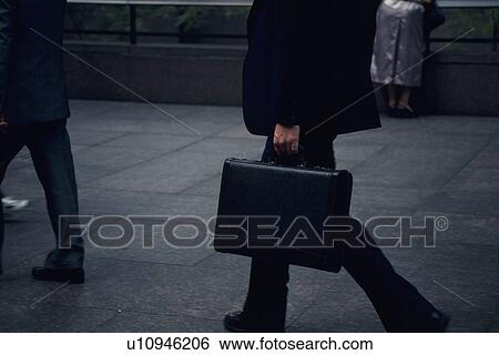 Stock Photograph - Business people walking down the street, side view, New York City, NY, USA. Fotosearch