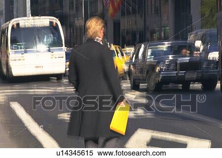 Businessman holding a yellow envelope in New York City, NY, USA View Large Photo Image Stock Photography - Businessman holding a yellow envelope in New York City, NY, USA. Fotosearch