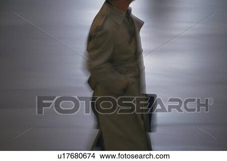 Businessman walking and holding a bag with hand in pocket, side view, New York City, NY, USA View Large Photo Image Picture - Businessman walking and holding a bag with hand in pocket, side view, New York City, NY, USA. Fotosearch