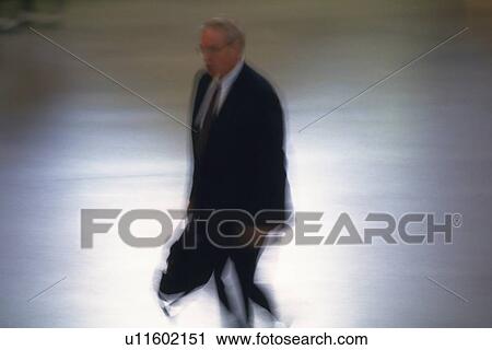 Businessman walking and holding a bag, high angle view, New York City, NY, USA View Large Photo Image Stock Image - Businessman walking and holding a bag, high angle view, New York City, NY, USA. Fotosearch
