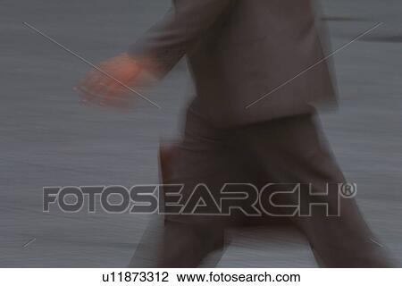 Businessman walking and holding a bag, side view, blurred motion, New York City, NY, USA View Large Photo Image Stock Image - Businessman walking and holding a bag, side view, blurred motion, New York City, NY, USA. Fotosearch