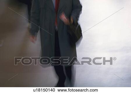 Businessman walking and holding a bag, high angle view, New York City, NY, USA View Large Photo Image Stock Image - Businessman walking and holding a bag, high angle view, New York City, NY, USA. Fotosearch