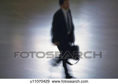 Businessman walking and holding a bag, high angle view, New York City, NY, USA View Large Photo Image Stock Photo - Businessman walking and holding a bag, high angle view, New York City, NY, USA. Fotosearch