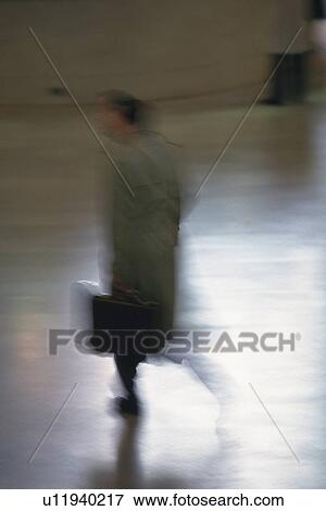 Businessman walking and holding a bag, high angle view, blurred motion, New York City, NY, USA View Large Photo Image Stock Photo - Businessman walking and holding a bag, high angle view, blurred motion, New York City, NY, USA. Fotosearch