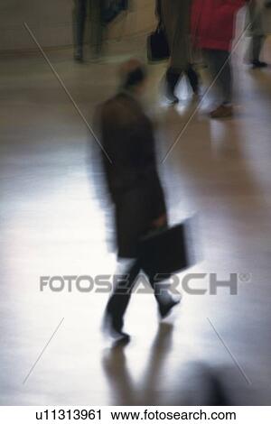 Businessman walking and holding a briefcase, high angle view, blurred motion, New York City, NY, USA View Large Photo Image Stock Image - Businessman walking and holding a briefcase, high angle view, blurred motion, New York City, NY, USA. Fotosearch