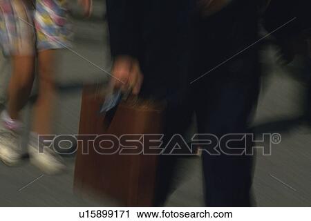 Businessman walking and holding a briefcase, front view, blurred motion, New York City, NY, USA View Large Photo Image Stock Image - Businessman walking and holding a briefcase, front view, blurred motion, New York City, NY, USA. Fotosearch
