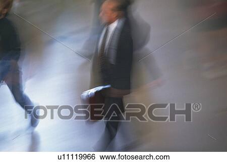 Businessman walking and holding a briefcase, high angle view, blurred motion, New York City, NY, USA View Large Photo Image Stock Photograph - Businessman walking and holding a briefcase, high angle view, blurred motion, New York City, NY, USA. Fotosearch