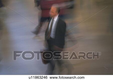 Businessman walking and holding a briefcase, high angle view, blurred motion, New York City, NY, USA View Large Photo Image Stock Photograph - Businessman walking and holding a briefcase, high angle view, blurred motion, New York City, NY, USA. Fotosearch