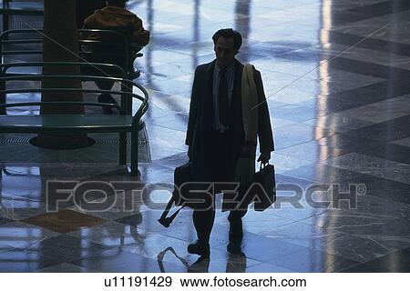 Businessman walking and holding bags, high angle view, New York City, NY, USA View Large Photo Image Stock Photo - Businessman walking and holding bags, high angle view, New York City, NY, USA. Fotosearch