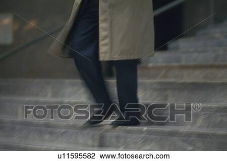 Businessman walking down the stairs, low angle view, blurred motion, New York City, NY, USA View Large Photo Image Stock Image - Businessman walking down the stairs, low angle view, blurred motion, New York City, NY, USA. Fotosearch