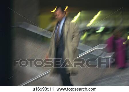 Businessman walking down the stairs, low angle view, blurred motion, New York City, NY, USA View Large Photo Image Stock Image - Businessman walking down the stairs, low angle view, blurred motion, New York City, NY, USA. Fotosearch