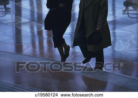 Picture - Businesswoman and businessman walking up stairs, high angle view, New York City, NY, USA. Fotosearch
