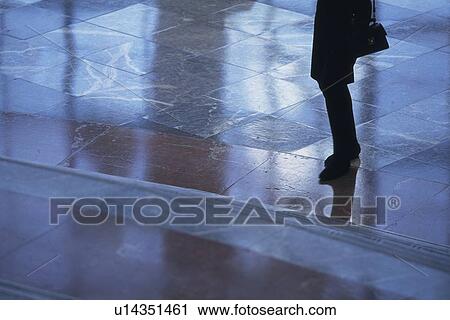 Stock Image - Businesswoman standing on floor, high angle view, New York City, NY, USA. Fotosearch