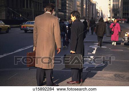 Two men standing on street corner, New York City, NY, USA View Large Photo Image Picture - Two men standing on street corner, New York City, NY, USA. Fotosearch