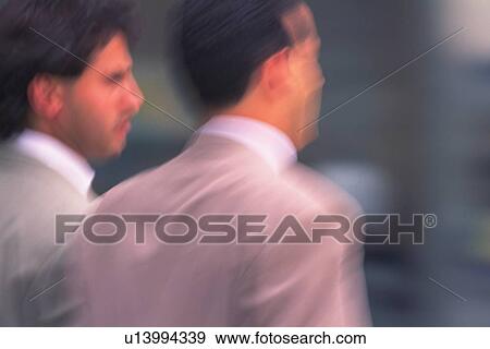Two men standing side by side, close up, blurred motion, New York City, NY, USA View Large Photo Image Stock Photo - Two men standing side by side, close up, blurred motion, New York City, NY, USA. Fotosearch
