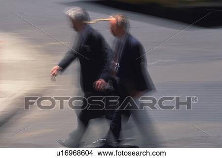 Two men walking side by side, high angle view, blurred motion, New York City, NY, USA View Large Photo Image Picture - Two men walking side by side, high angle view, blurred motion, New York City, NY, USA. Fotosearch