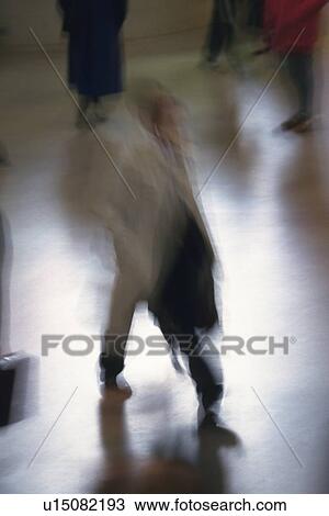 Stock Image - Walking businessman, high angle view, blurred motion, New York City, NY, USA. Fotosearch