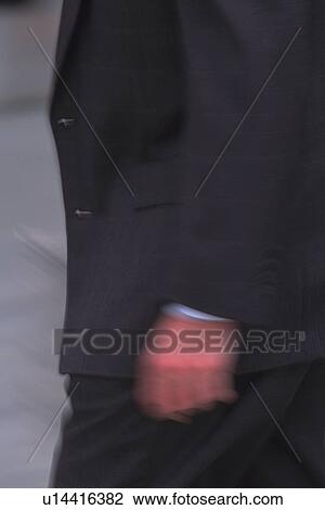 Stock Image - Walking businessman, side view, close up, blurred motion, New York City, NY, USA. Fotosearch