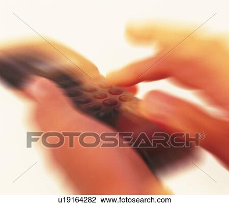 Businessman holding a mobile phone and pushing buttons, close up, high angle view, blurred motion View Large Photo Image Stock Image - Businessman holding a mobile phone and pushing buttons, close up, high angle view, blurred motion. Fotosearch