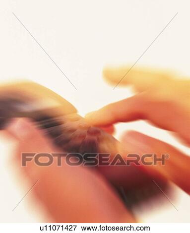 Businessman holding a mobile phone and pushing buttons, close up, high angle view, blurred motion View Large Photo Image Stock Photo - Businessman holding a mobile phone and pushing buttons, close up, high angle view, blurred motion. Fotosearch