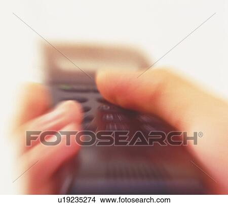 Picture - Businessman holding a mobile phone, close up, low angle view, blurred motion. Fotosearch