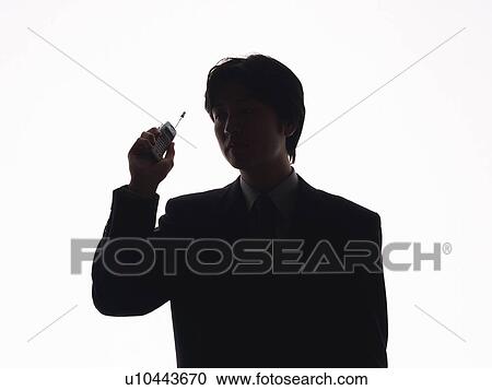 Businessman holding a mobile phone, front view View Large Photo Image Stock Image - Businessman holding a mobile phone, front view. Fotosearch